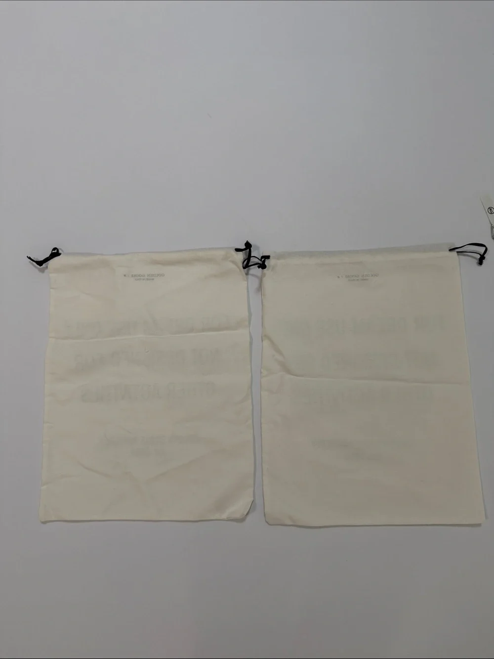Golden Goose Cream Canvas Drawstring Bags with Black Text (Pair)